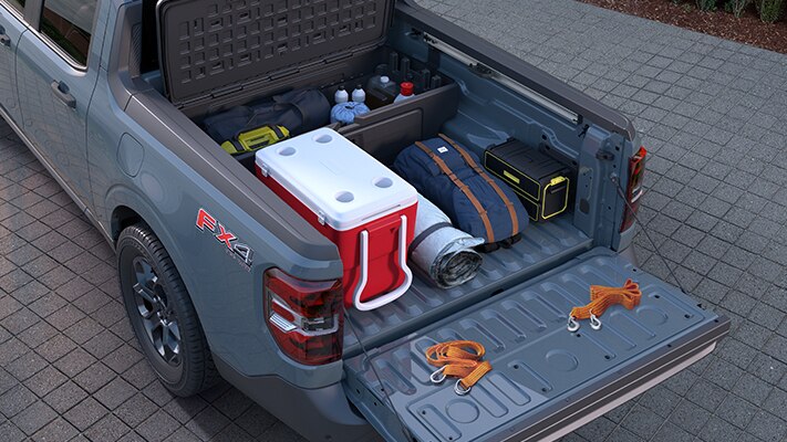 The bed of the Maverick® pickup loaded up with camping gear.